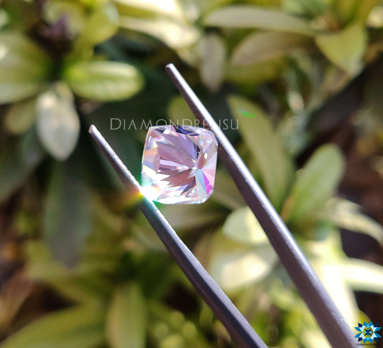 Cushion cut moissanite loose stone crafted in 5.18 carat size with a colorless shine.
