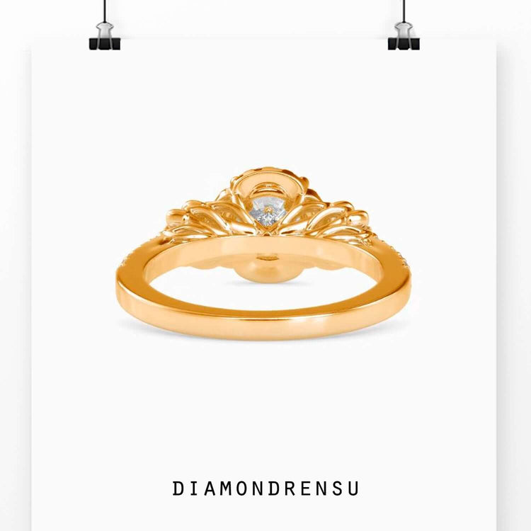 Rose gold flower ring with a round halo and pave engagement ring style.
