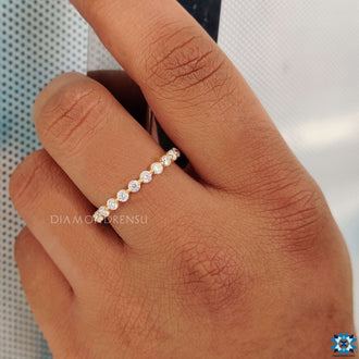 Round eternity band featuring sparkling, flawless gemstones.