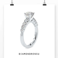 Engagement ring with pave stones surrounding the round diamond for added brilliance.