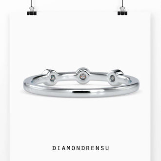 Three stone bezel ring with round diamonds in a yellow gold band
