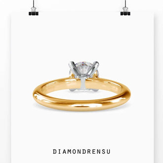 Handmade round solitaire engagement ring with a peek-a-boo diamond accent, available in rose, yellow, or white gold.
