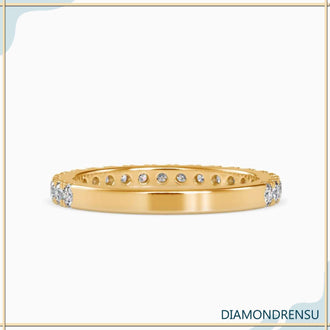 Pave wedding band featuring rounded diamonds set in gold for a classic style.
