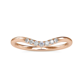 Curved diamond wedding band in rose gold with sparkling accents
