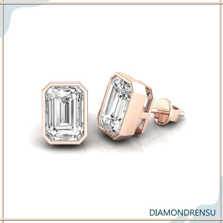 Elegant emerald cut diamond earring in a bezel setting, perfect for special occasions.

