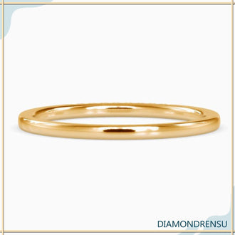 Lab Grown Diamond eternity wedding band in yellow gold with u prong setting.
