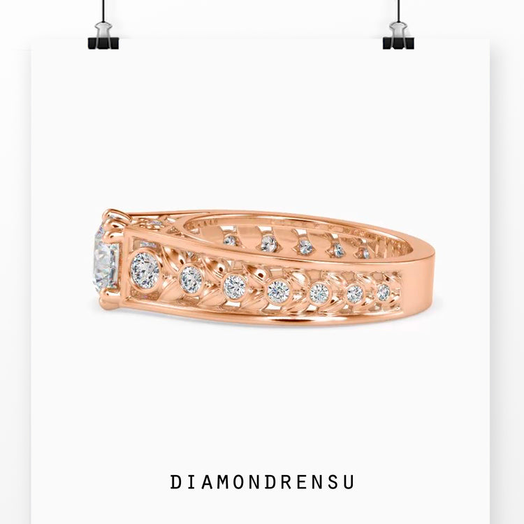 Double prong ring with round brilliant cut diamond and filigree accents.