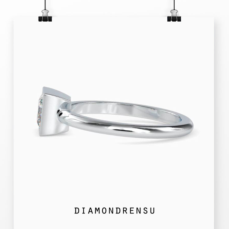 Timeless princess cut solitaire diamond ring with a secure bezel setting for extra shine.