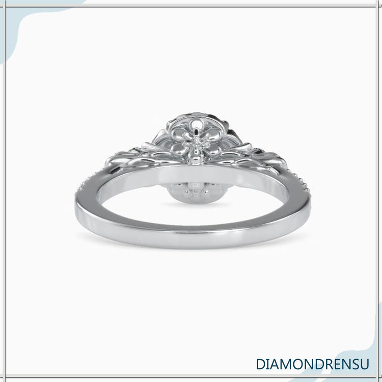 Three stone round engagement ring with a gold pave band.