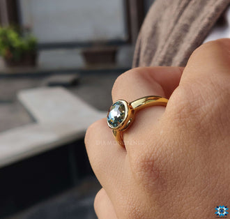 Bezel set moissanite ring with a flawless finish.