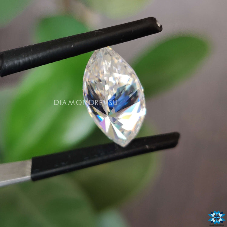 Loose marquise stone shimmering next to moissanite marquise loose stone.
