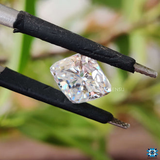 Cushion cut moissanite glowing beside moissanite loose stone.
