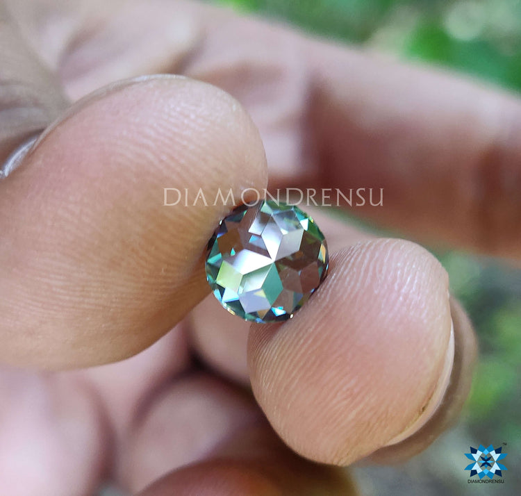 Loose moissanite shown as 2 carat green moissanite with round rose cut style from Diamondresnu.
