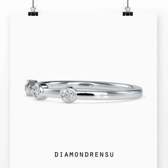 Handmade bezel set eternity band with round diamonds in rose gold
