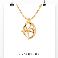 The gold pendant adds a warm, classic touch to any outfit.
