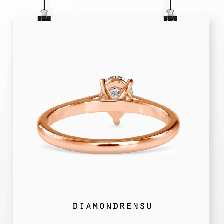 Gold pear shaped engagement ring featuring a pear solitaire and handmade jewelry craftsmanship.
