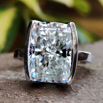 Elongated cushion engagement ring with sparkling moissanite.