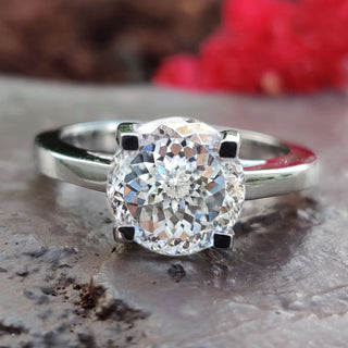 Round Portuguese cut Moissanite set in a dazzling engagement ring.
