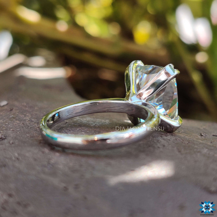 Solitaire cushion cut engagement ring with exquisite craftsmanship.
