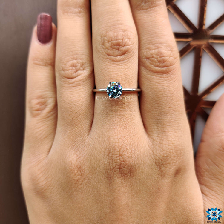A six prong round engagement ring highlighted with sparkling details.
