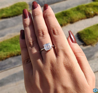Stunning Asscher cut engagement ring on a velvet jewellery box.
