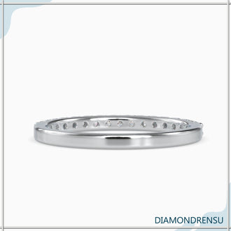 Simple gold prong setting diamond eternity band.