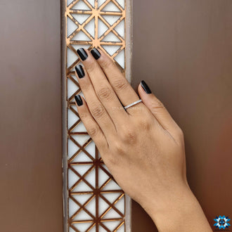 Full eternity band with round moissanite gems in prong setting.