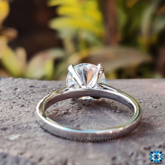 Round solitaire cathedral setting perfect for romantic occasions.