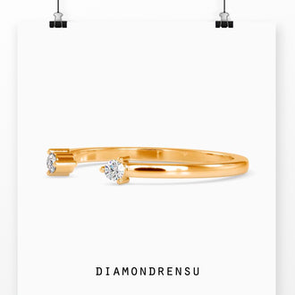 Open cuff wedding band with a delicate and dainty two stone setting.
