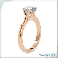 Classic round solitaire engagement ring with a twisted basket setting for modern elegance.