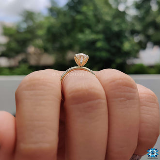 A tulip setting ring featuring a brilliant gemstone cradled in elegant, petal-like prongs.