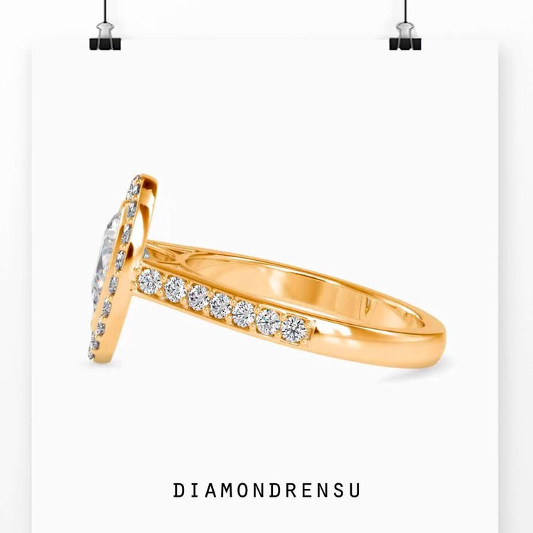 Bridge ring featuring a pear shape diamond and halo setting.
