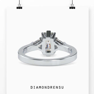 Stunning trillion cut emerald with a diamond basket setting for secure brilliance.