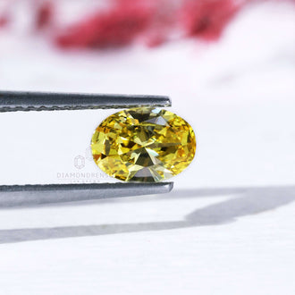 0.70 carat oval cut loose lab grown yellow diamond.
