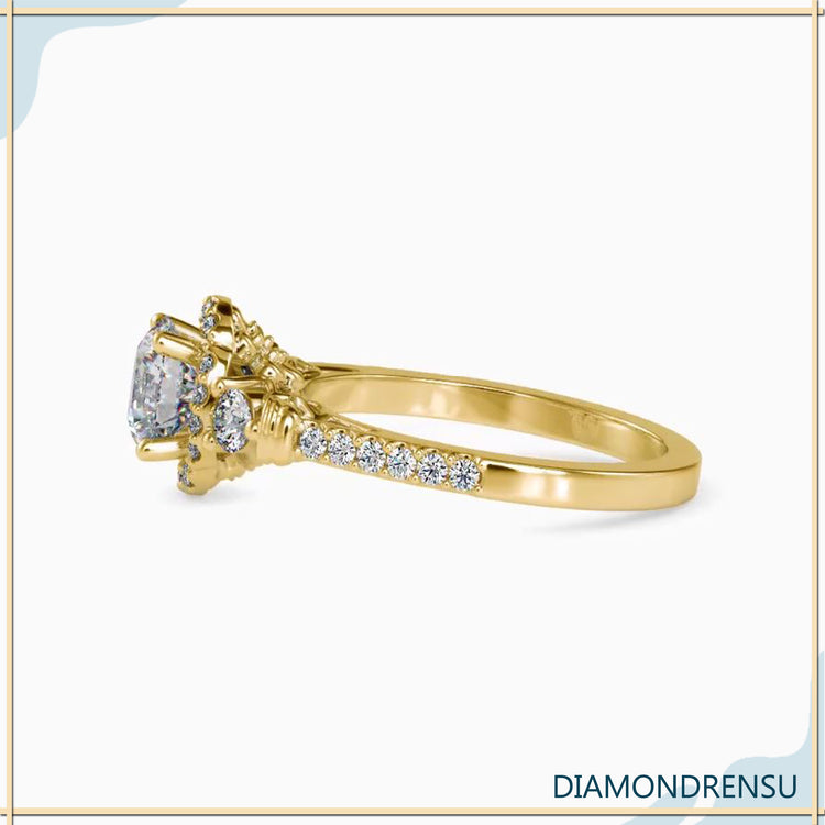Gold pave ring with a floral design and halo engagement setting.
