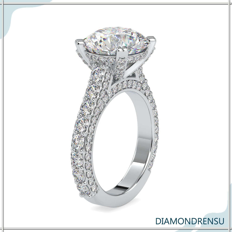 Pave setting ring with a round diamond and side stone details.
