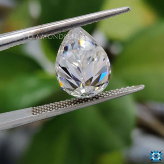 Moissanite stone shining next to pear rensu cut moissanite.
