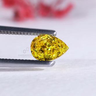 Yellow pear diamond in 1.10 carat cushion cut shown as a loose diamond.
