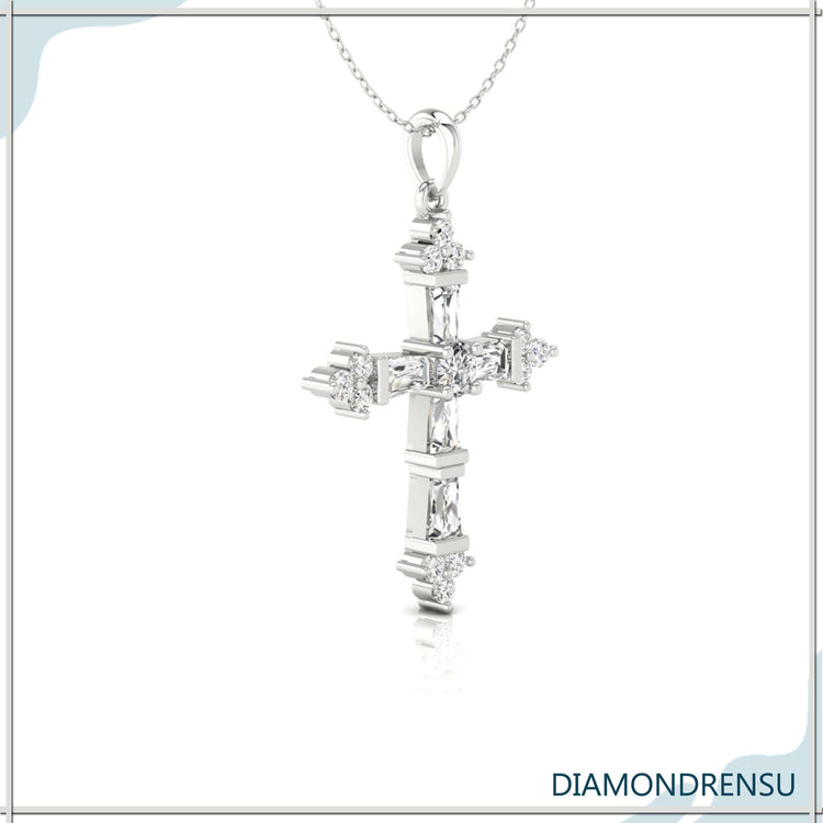 Tapered baguette and round diamond cross pendant in handmade jewelry design.
