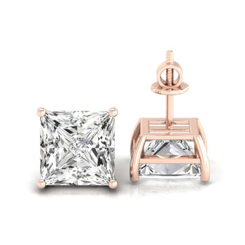 Princess cut diamond earrings set in a four-prong basket setting, perfect for a luxurious look.
