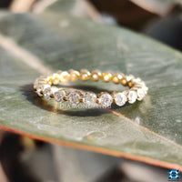 Eternity band round design with floating bubble prongs.