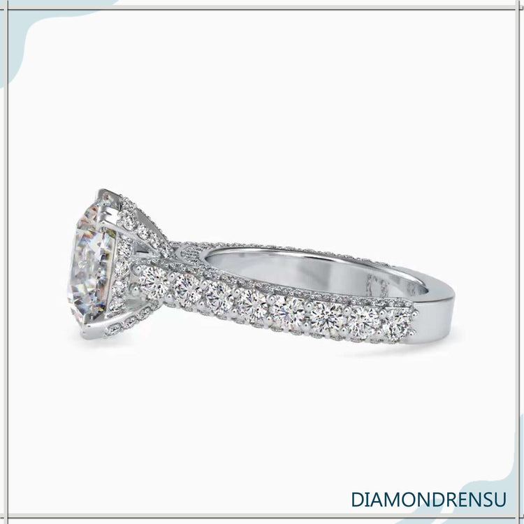 Hidden halo setting with a round diamond and cathedral design.
