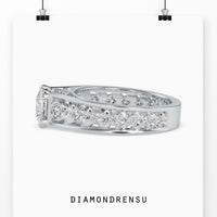 Round engagement ring featuring a peekaboo diamond design.
