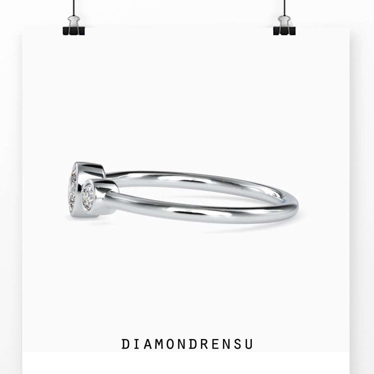 Bezel set engagement ring featuring a handmade design in rose gold
