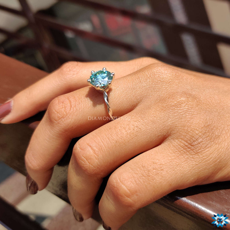 Handmade ring featuring a round brilliant cut moissanite.
