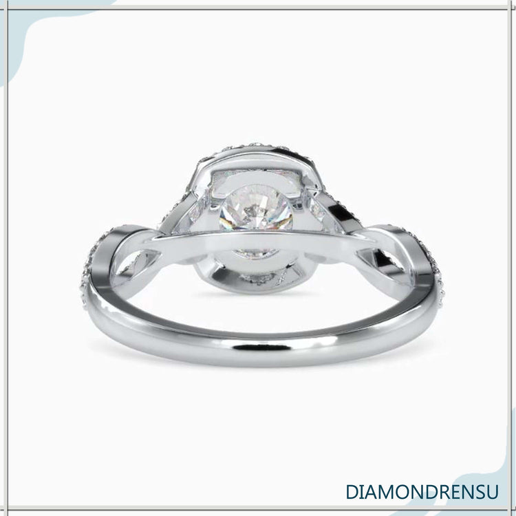 Halo engagement ring featuring a pave twist and round diamond.
