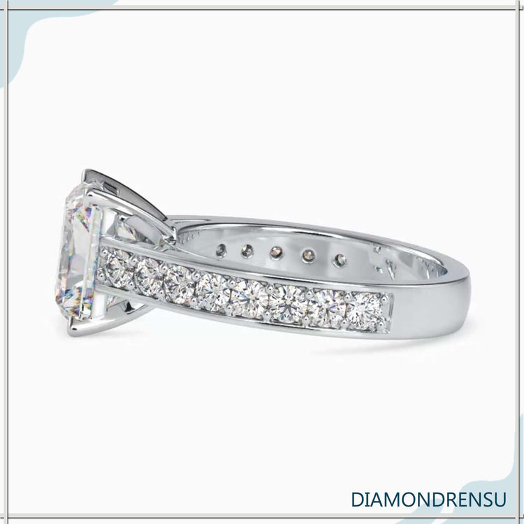 A moissanite radiant cut ring in a cathedral ring setting, blending classic and contemporary styles.
