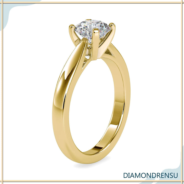 Round brilliant cut diamond ring with prong tabs in cathedral setting
