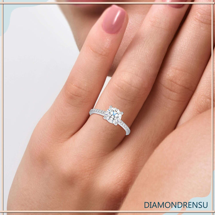 Pave engagement ring with a diamond prong setting, crafted in a cathedral style.