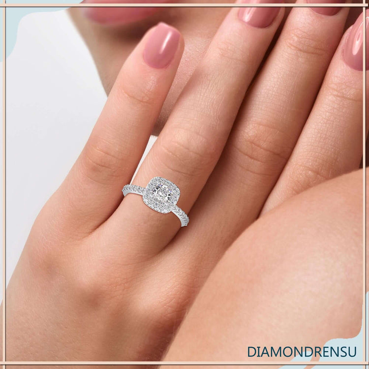 Double halo ring with a cushion cut diamond and a pave band engagement ring style.